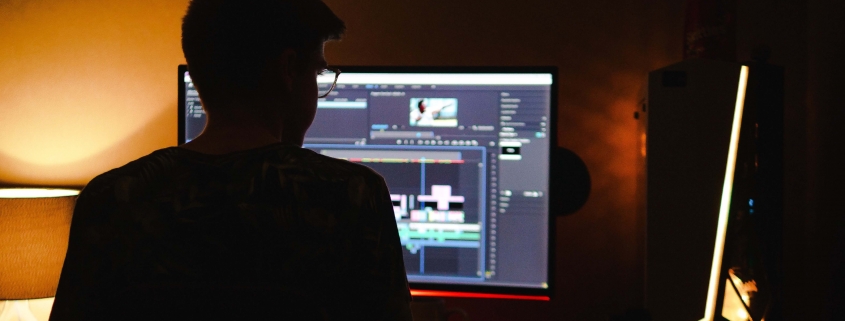 Man at screen editing at home
