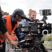 Rob Sarkies looking through a camera on set